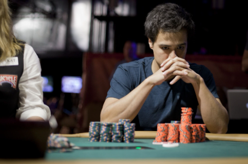 "Poker table with Texas Hold’em game, two hole cards dealt to each player, and community cards on the board."